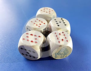 white dices with playing cards symbols on ble background photo