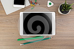 White digital tablet and mobile phone on an office working dark wooden table