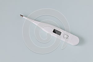 White digital thermometer on a gray background