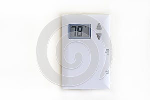 White digital thermostat on antique white wall