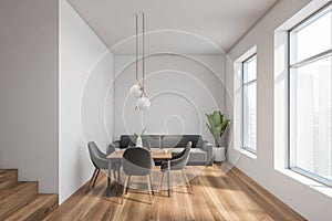 White dining room interior with gray sofa