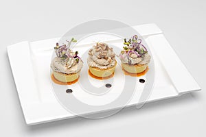 White dish with 3 cups of roe salad