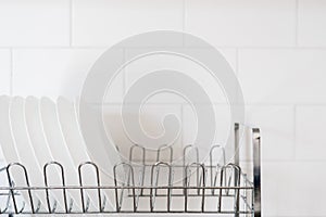 White dishes after washing in special drainer