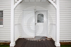 White door entrance of home wooden facade house architecture detail style New Orleans Louisiana