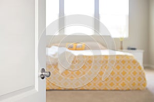 White door opened to bedroom, blurred background