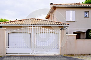 White door steel gate slats portal of suburb house with two entrance garage door