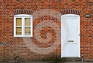 White door and window on brick wall background.