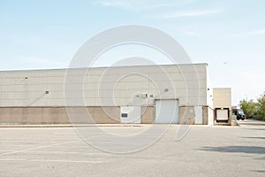 white doors and receiving bay doors on large one story beige building 205 p 17