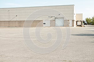 white doors and receiving bay doors on large one story beige building 206 p 17