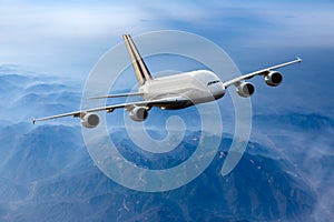 White double decker passenger plane in flight. Front view.