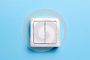 White double light switch isolated on blue background