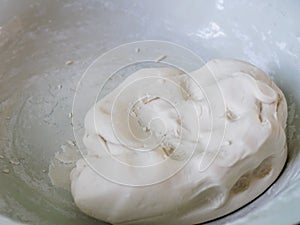 White dough preparation in bowl for make sweet dessert, bakery cooking at home. Concept of food making at home