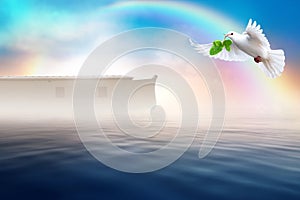 White dove flying with olive branch in its beak