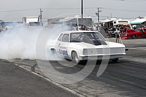 White drag car burnout