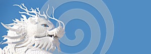 White dragon statue on blue sky background.Dragon is fairy tale monster in many culture around the world