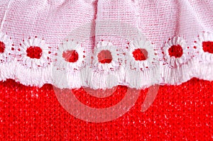 White drape with circles on red fabric.