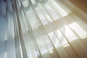 White drapery curtain hanging on the window