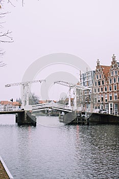 White drawbridge over the water of the river in Haarlem, Netherlands.