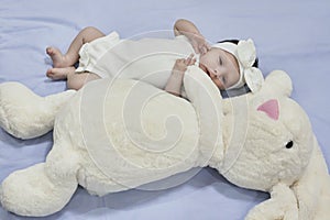 Newborn baby girl with her bunny