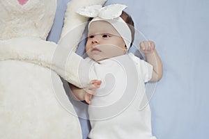 Newborn baby girl with her bunny