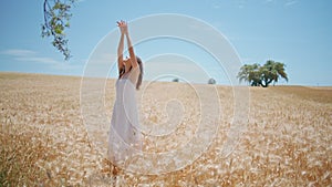 White dress model summer enjoying at cereal nature. Young woman posing at field