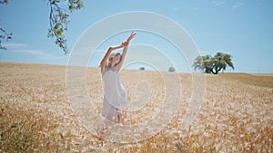 White dress model summer enjoying at cereal nature. Young woman posing at field