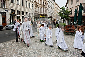 White dressed children on the road to the Catholic Church