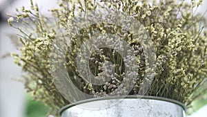 White dried flowers bouquet metal vase bucket