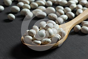 White dried haricot kidney beans on wooden table