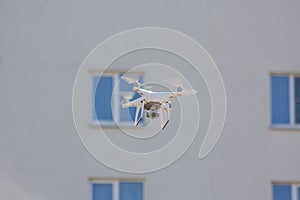 White drone flying above the building