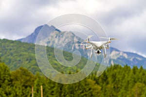 White drone flying above mountains