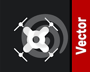 White Drone flying icon isolated on black background. Quadrocopter with video and photo camera symbol. Vector