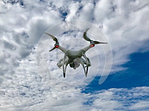 White Drone quadcopter With Blue Sky and Clouds