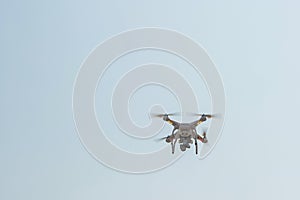 White drone, quadrocopter, with photo camera