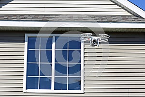 White drone, spying on home windows