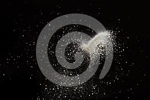 White dust debris isolated on black background photo