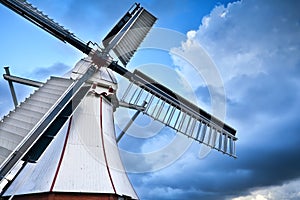 White Dutch windmill over blue sky