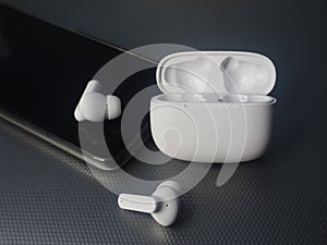white earbuds and smart phone connect together
