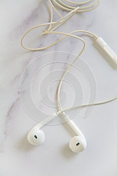 White earphone and cable with blurred background