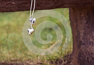 White earphone hanging on table