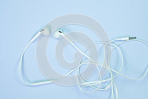 White Earphones or ear buds small talk on sweet blue colour past