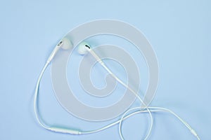 White Earphones or ear buds small talk on sweet blue colour past