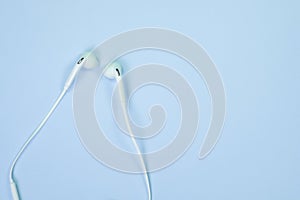 White Earphones or ear buds small talk on sweet blue colour past
