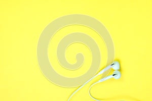 White Earphones or ear buds small talk on sweet yellow colour pa