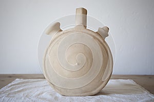 White earthenware botijo, traditional clay pot jug