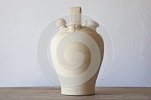 White earthenware botijo, traditional clay pot jug photo