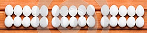 White easter eggs in row on wood background