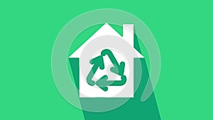 White Eco House with recycling symbol icon isolated on green background. Ecology home with recycle arrows. 4K Video