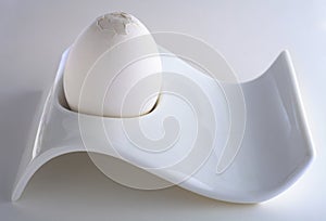 White egg in eggcup with cracked top