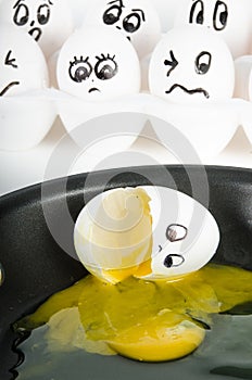 White egg with face broken in skillet